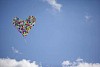 Balloons in the sky forming a heart shape