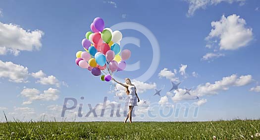 Girl walking with a  bunch of balloons
