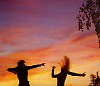 Male and female dancing on the sunset