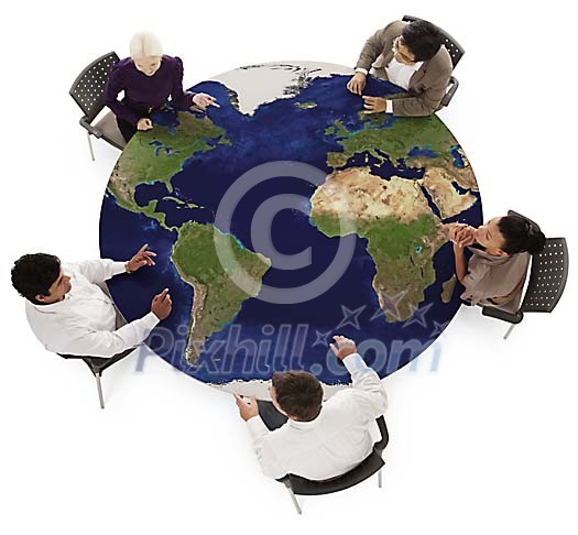 Multicultural group having a meeting around a table with imprinted map of the earth