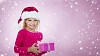 Girl with santa hat and gift in pink with stars