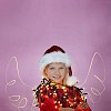 Long exposure of a girl with christmas lights and drawn light wings