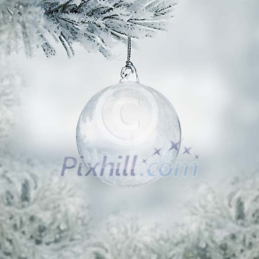 Transparent christmas ball hanging on a frozen fir outside seen through the window