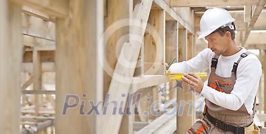 Construction worker measuring