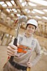 Female constructor holding up hammer