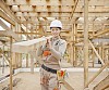 Female constructor carrying wood