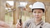 Closeup of a woman hammering a nail