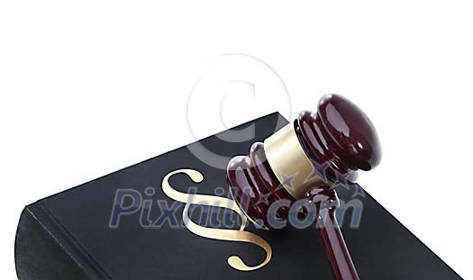 Wooden gavel laying on conceptual law book