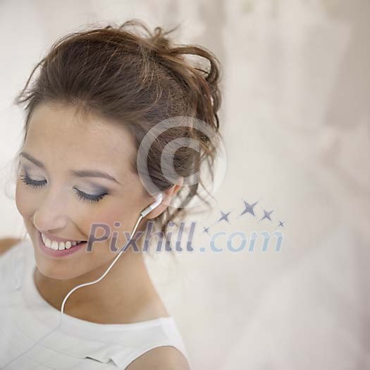 Young female with earplugs behind window