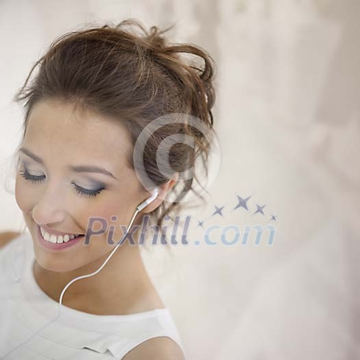 Young female with earplugs behind window Young female with earplugs behind window