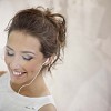 Young female with earplugs behind window