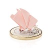 Small pink paper pig standing on big euro coin