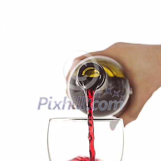 Hand pouring red wine into glass