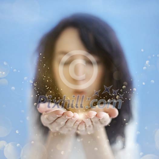 Girl blowing golden glitters in the air Girl blowing golden glitters in the air