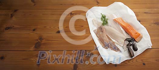 Collection of raw fish on wooden background