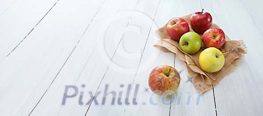 Collection of apples on a wooden background