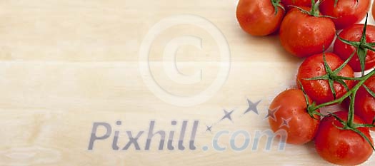 Group of tomatoes on wooden background