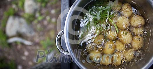 Potatoes in boiling water outdoors