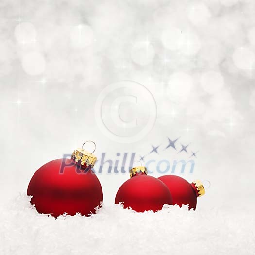Red christmas balls on white snow