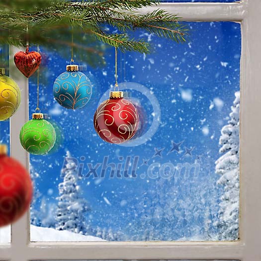 Christmas balls in front of the window
