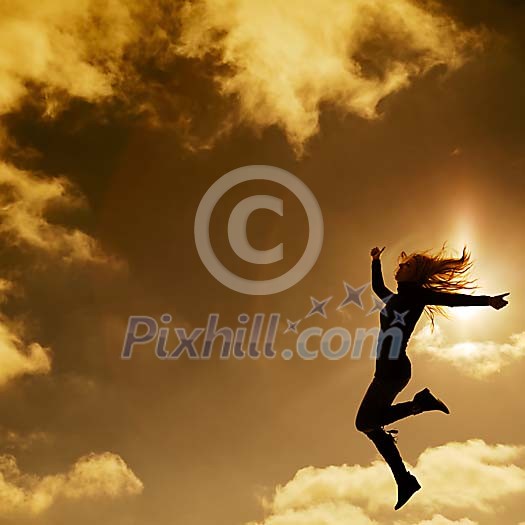 Girl jumping in evening sky Girl jumping in evening sky
