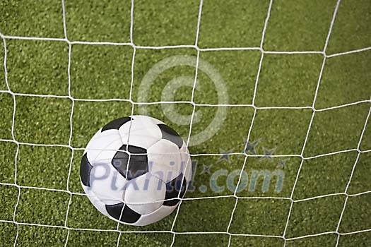 Soccer ball behind the net