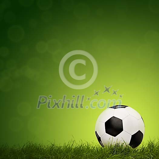Football with grass on green background