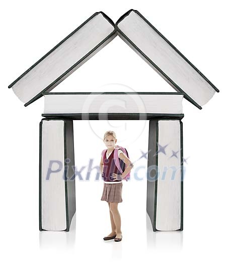 Isolated girl standing in front of building made out of books