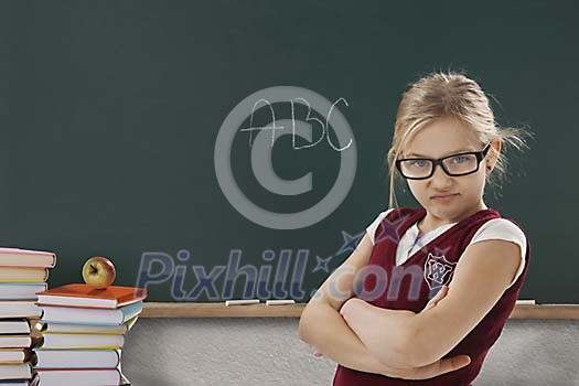 Girl student standing in front of blackboard