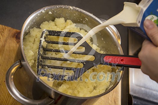 Pouring milk on mash potatoe Pouring milk on mash potatoe