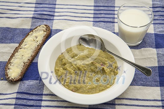 Pea soup with bread and a glass of milk Pea soup with bread and a glass of milk