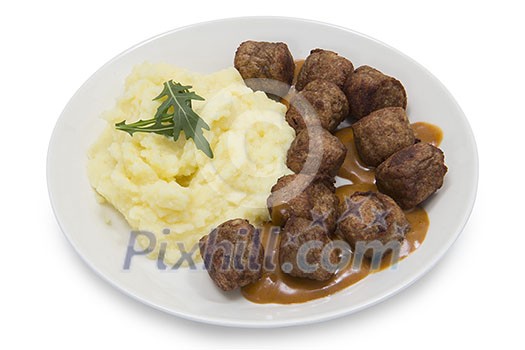Isolated plate of mash potatoes with meatballs and sauce Isolated plate of mash potatoes with meatballs and sauce