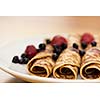 Rolls of pancakes with berries