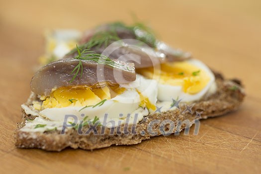 Rye bread with boiled eggs and herring