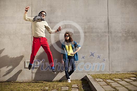 Hipster couple outside jumping and posing Hipster couple outside jumping and posing