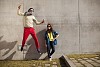 Hipster couple outside jumping and posing