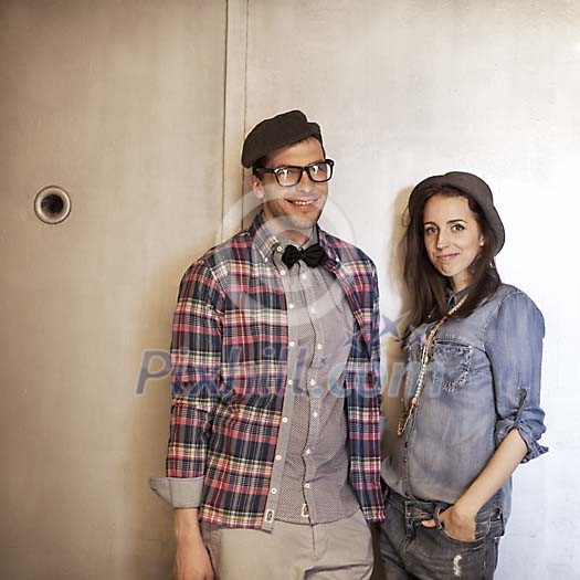 Smiling man and a woman standing by the door Smiling man and a woman standing by the door