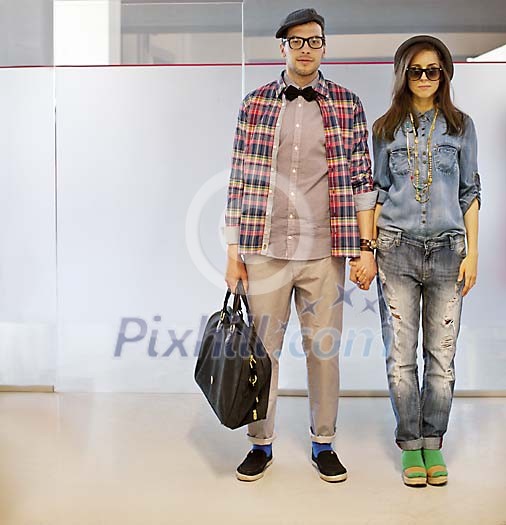 Trendy man and woman standing in the corridor