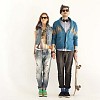 Hipster couple standing by the wall