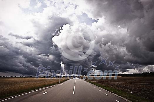 Empty road under the cloudy sky