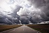 Empty road under the cloudy sky