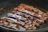 Bacon slices on a hot pan