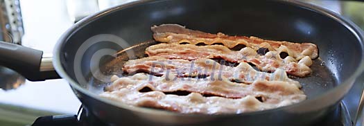 Bacon slices on a hot pan
