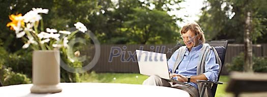 Man sitting outside with laptop Man sitting outside with laptop