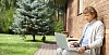 Man sitting by the wall with laptop