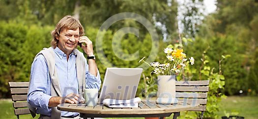 Man doing office work in the garden