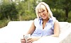 Smiling woman sitting on the terrace