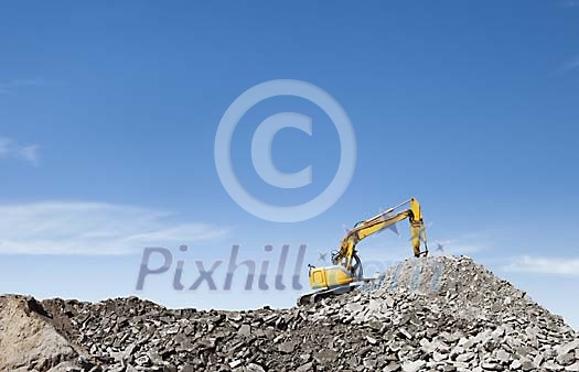 Excavator working on the crushed stone hill