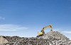 Excavator working on the crushed stone hill