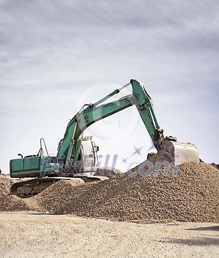 Excavator working on a rubble hill